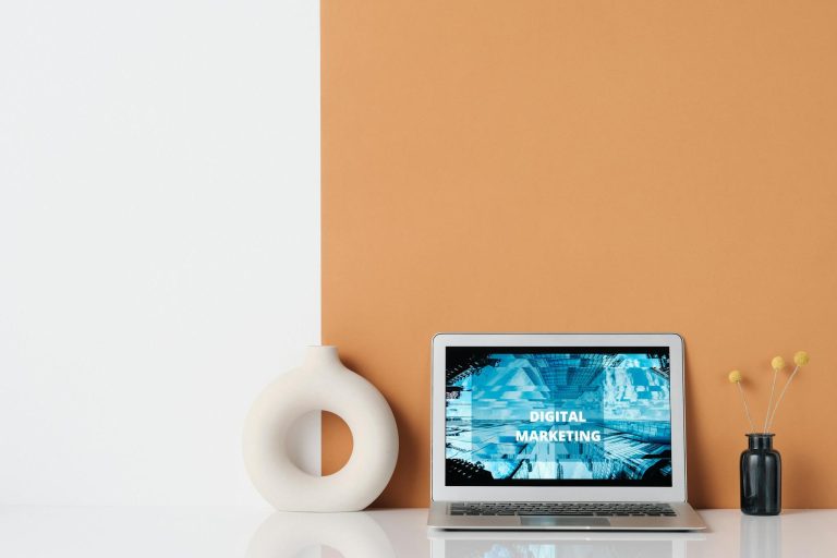 Ceramic Vase beside a Laptop